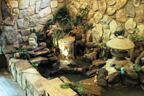 The wall behind the pond was rocked to integrate the look