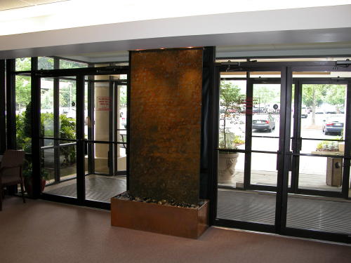 An artistic wate rwall gives visitors a great first impression